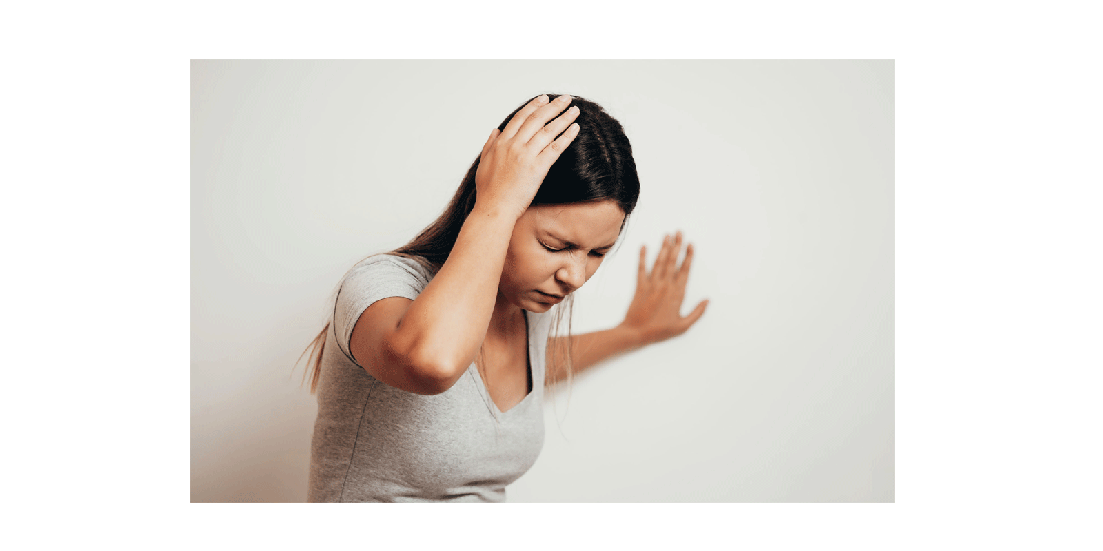 woman-hand-to-head-balance-wall-headache